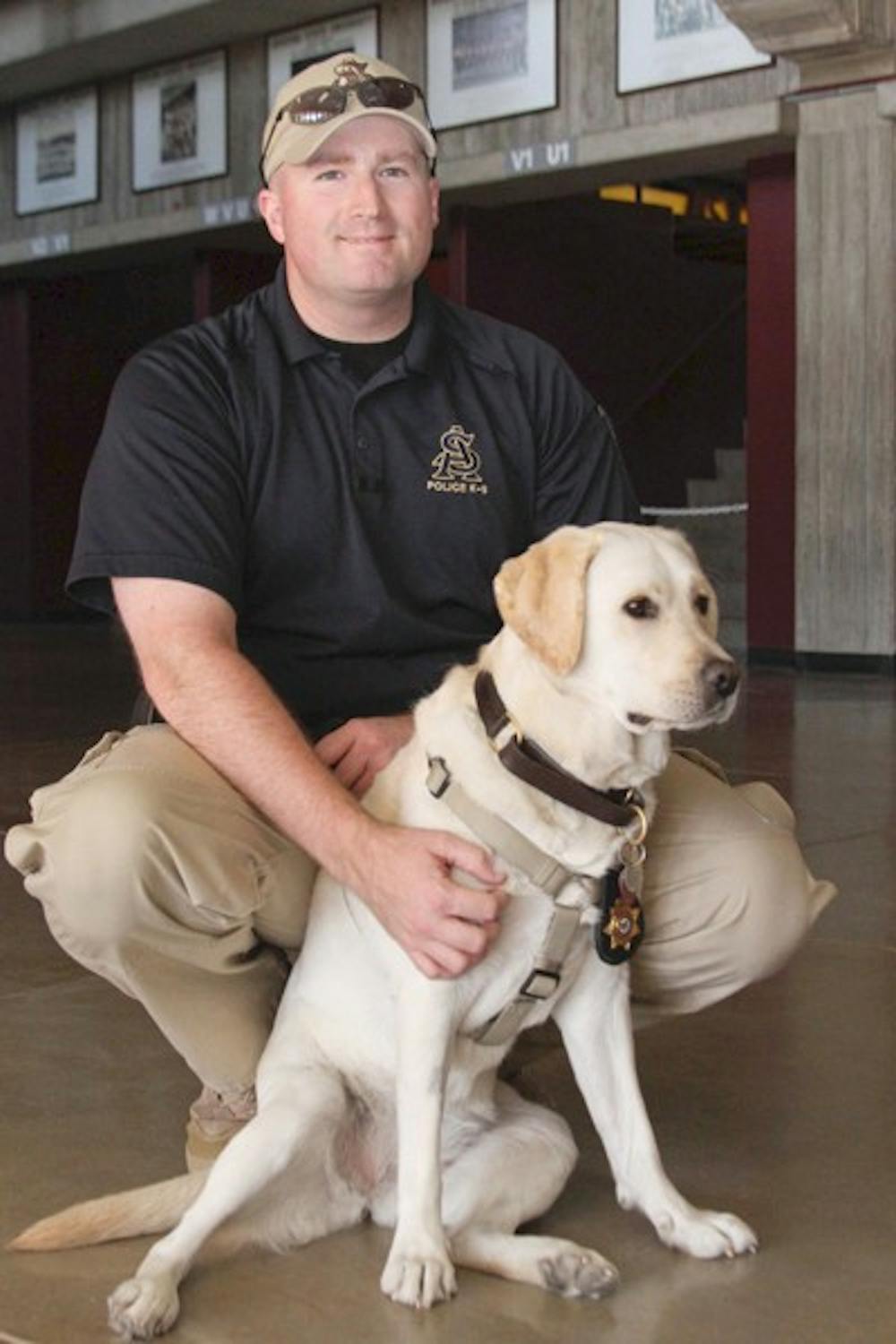K-9 DETECTIVE: ASU's first police dog, Disney, poses with her handler Detective Parker Dunwoody.  Disney is specially trained to smell explosives and firearms and will be used for on-campus security. (Photo by Lisa Bartoli)