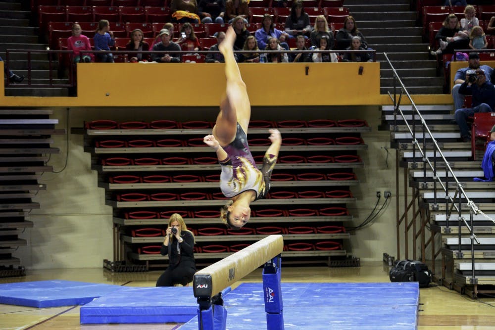 ASU junior Allie Salas performs her balance beam routine against Stanford on Saturday Jan. 31, 2015, at Wells Fargo Arena in Tempe. Salas finished her routine with a score of 9.725. (Krista Tillman/ The State Press)