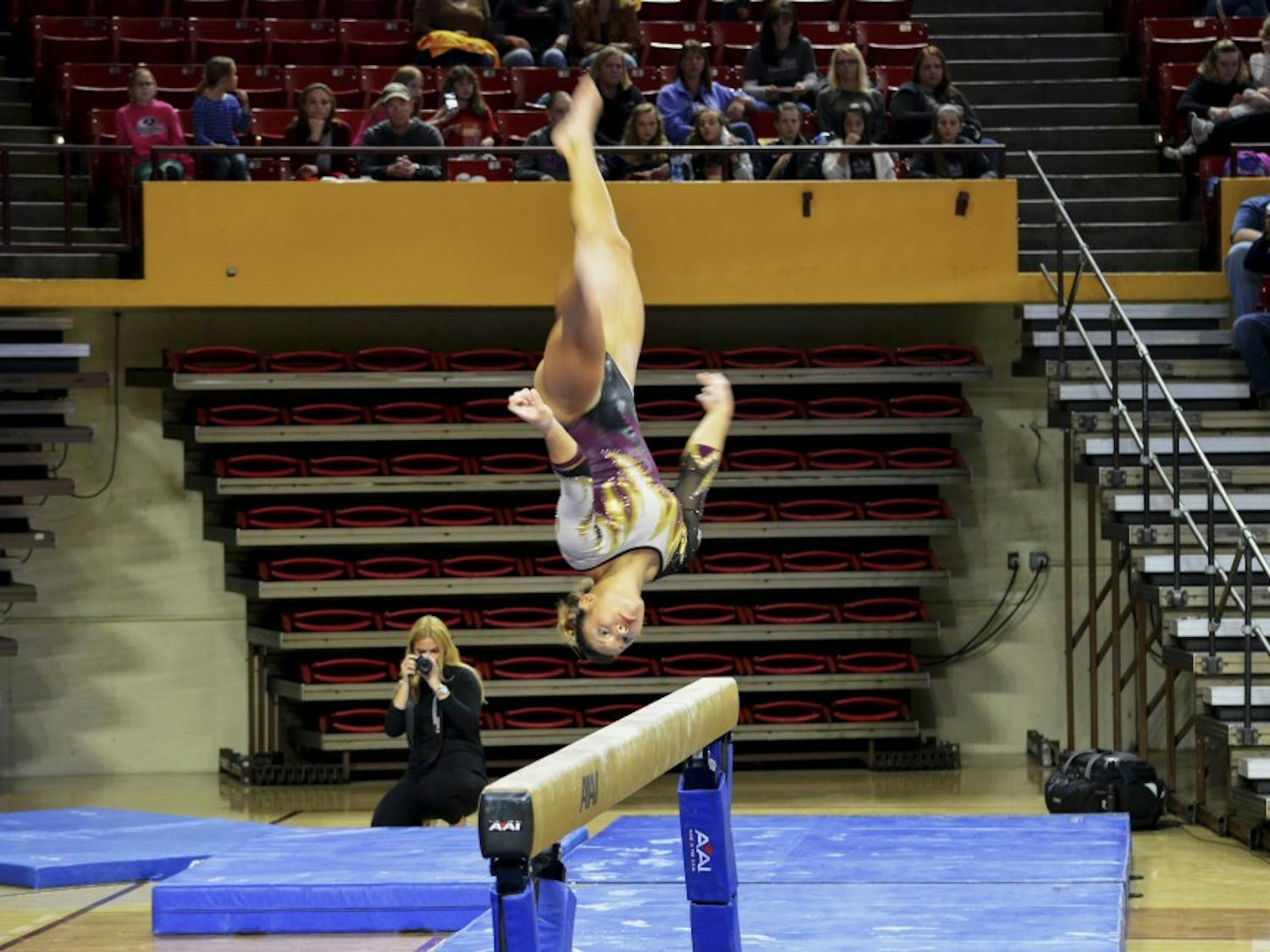 ASU junior Allie Salas performs her balance beam routine against Stanford on Saturday Jan. 31, 2015, at Wells Fargo Arena in Tempe. Salas finished her routine with a score of 9.725. (Krista Tillman/ The State Press)