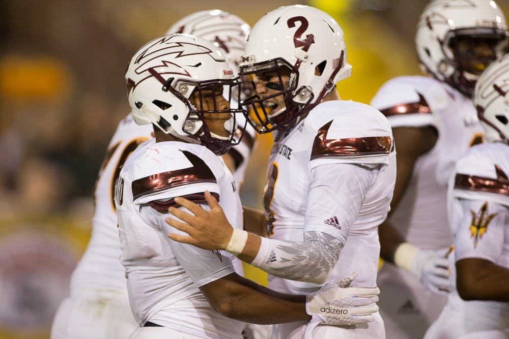 Redshirt senior quarterback Mike Bercovici celebrates with sophomore running back Demario Richard on Friday, Sept. 18, 2015, at Sun Devil Stadium in Tempe.