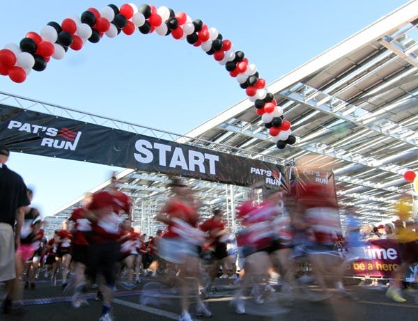 A slow shutter speed blurs runners at the starting line of the eighth annual Pat's Run in Tempe Saturday morning. (Photo by Lisa Bartoli)