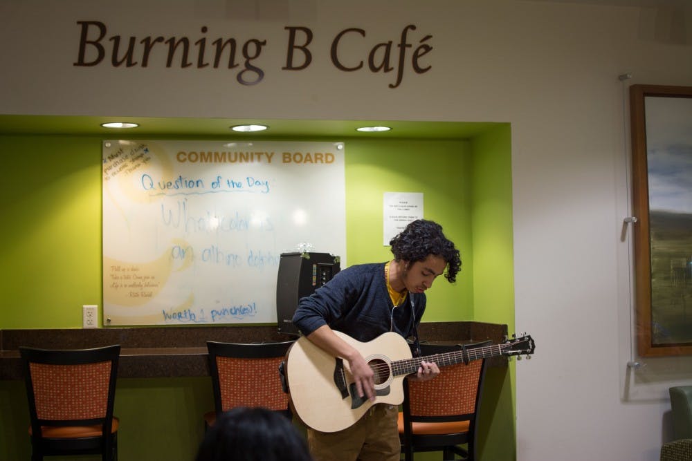 Samuel Leal, an ASU freshman studying creative writing, plays his guitar and sings an original song on Wednesday, Feb. 8, 2017 at an open-mic night in Barrett, the Honors College’s Burning B Café. 