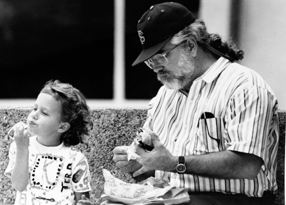 KETCH-IN UP ON LUNCH: Five-year-old ASU student Kelsey Wolf gets pure enjoyment out of eating the ketchup right out of the packet in 1992. (Photo by Darryl Webb)
