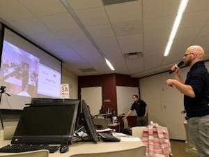 Graduate student Guido Caniglia begins video transmission with a class from Leuphana University. Global classrooms have cameras connecting both rooms and students discuss topics using microphones. (Photo by Andrew Ybanez)