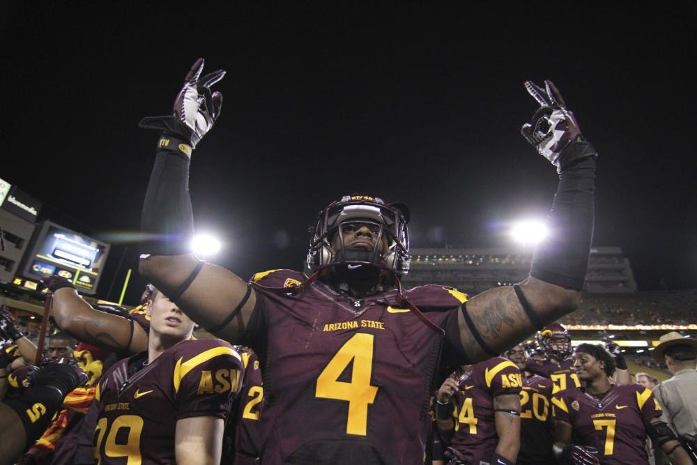 Defensive back Alden Darby throws his arms up during a home game in Tempe. Darby is projected to start this fall with the Sun Devils. (Photo by State Press Staff)