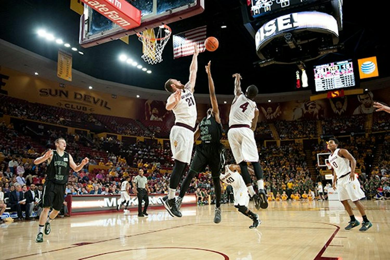 Junior forward Eric Jacobsen (left) and junior guard Gerry Blakes attempt to block a Chicago State shot, Friday. Nov. 14, 2014 at Wells Fargo Arena in Tempe. The Sun Devils defeated the Cougars 81-67. (Photo by Ben Moffat)