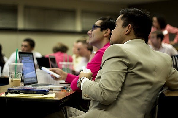 Senator John Oyas uses his clicker to vote for a bill at a USG meeting on Oct. 7, 2014. (Photo by Alexis Macklin)