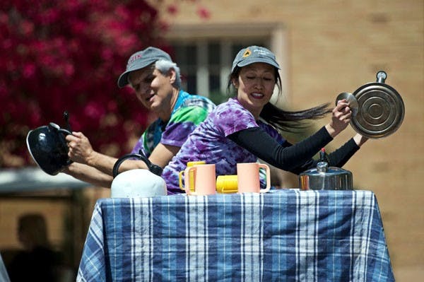TRASH TO MUSIC: Husband and wife team Step Raptis and Lisa Chow of "Step's Junk Funk" perform on Hayden Lawn during celebrations for Earth Week. Raptis, who has been converting trash into percussion instruments since 1973, enjoyed a stage powered entirely by solar energy. (Photo Michael Arellano)