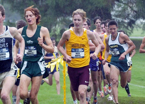 Then-junior Nick Happe looks to pass Cal Poly’s Carl Dargitz through rain during last season’s NCAA West Regional meet in Oregon in 2011.