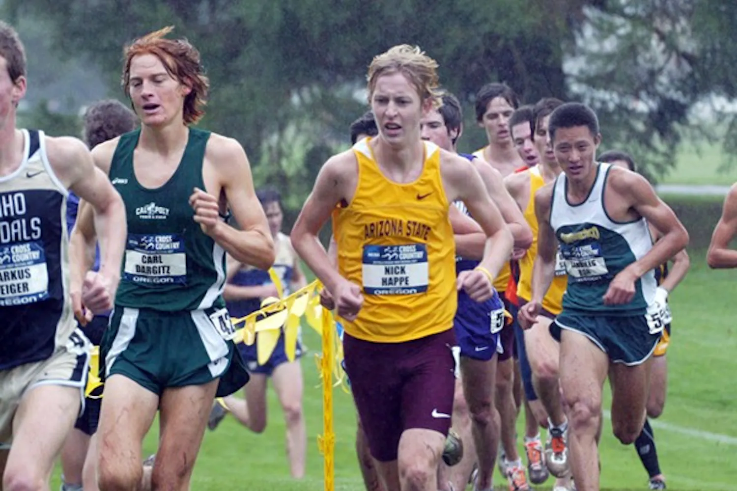 Then-junior Nick Happe looks to pass Cal Poly’s Carl Dargitz through rain during last season’s NCAA West Regional meet in Oregon in 2011.