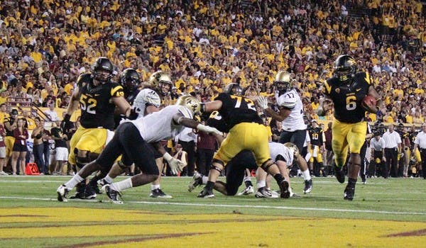 MUCH BETTER: Junior running back Cameron Marshall crosses the goal line for a touchdown during the first quarter of the Sun Devils’ 48-14 win over the Buffaloes on Saturday. Marshall rushed for 114 yards and three touchdowns after using the team’s bye week to rest an ankle injury. (Photo by Beth Easterbrook)