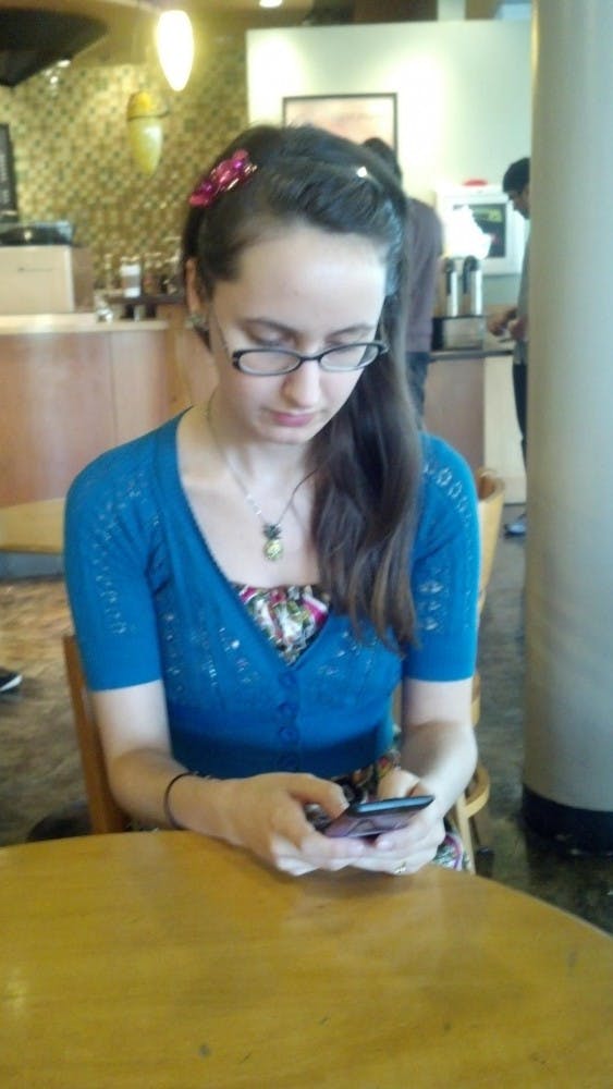 Erika Jacobs feels that smartphones are unnecessary, but her LG Lotus and laptop accomplish everything she needs. Photo by Courtland Jeffrey.