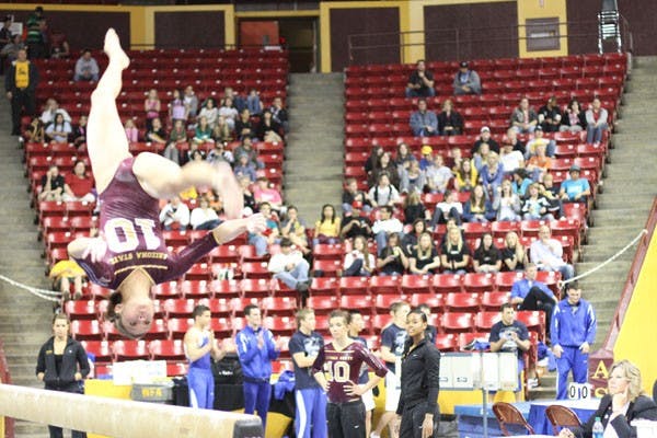 FANCY FOOT WORK: Sophomore Kahoku Palafox mid air on the balance beam in the home meet against Stanford on Friday. Palafox earned a 9.725 on the balance beam. (Photo by Nikolai de Vera)