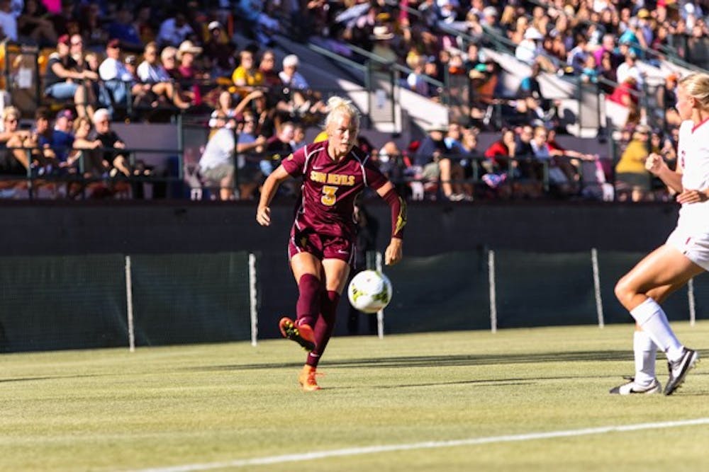 Junior defender McKenzie Berryhill unleashes a centering pass during the ASU vs Arizona soccer game on Friday, Nov. 7, 2014. Berryhill’s stout defense helped the Sun Devils shutout the Wildcats 1-0. (Photo by Daniel Kwon)
