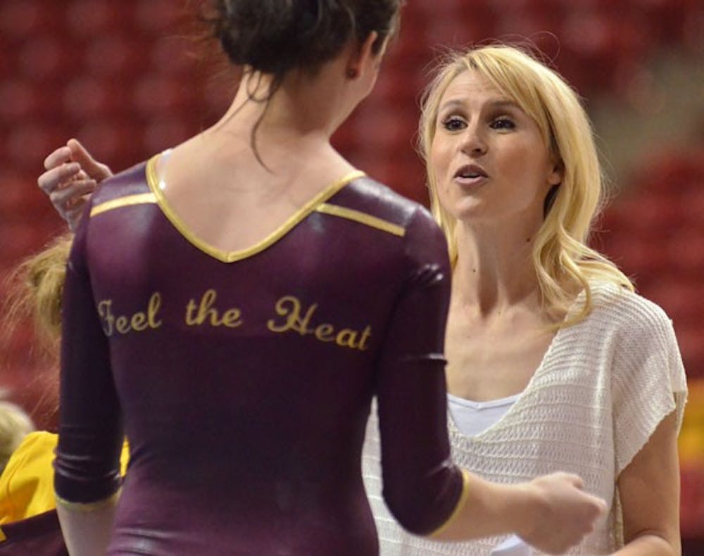ASU assistant coach Kari Ward gives instructions during Sunday’s loss to No. 7 Oregon State. Her ability to relate to the gymnasts has made her popular on a team where the other coaches are men. (Photo by Aaron Lavinsky)