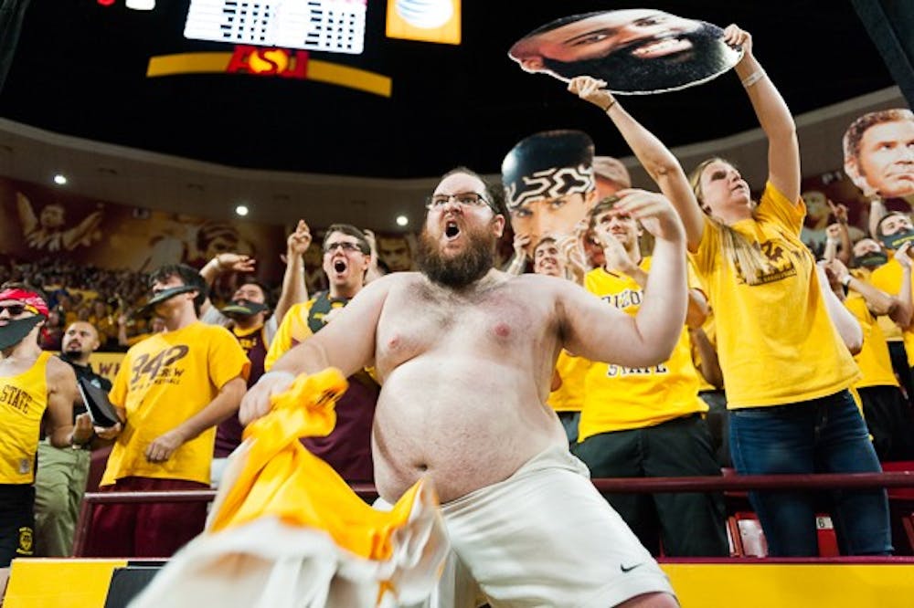 ASU alumnus Nate McWhortor dances behind the "Curtain of Distraction" during the second half of the ASU men's basketball game against UCLA, Wednesday, Feb. 18, 2015, at Wells Fargo Arena in Tempe. (Ben Moffat/The State Press)