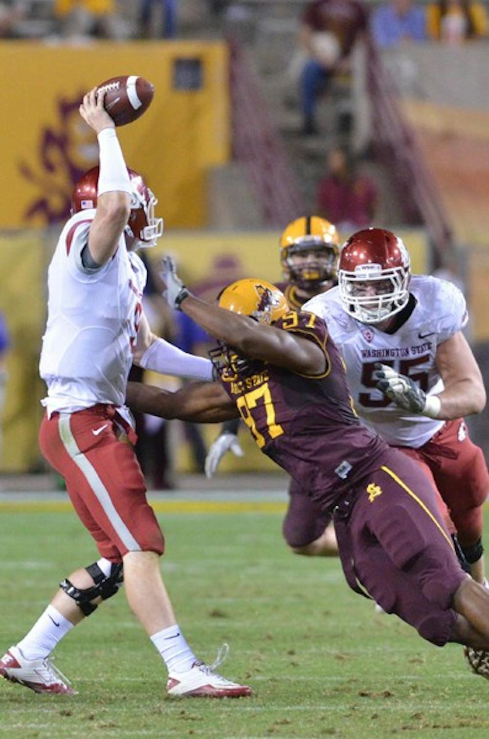 STRUGGLE FOR CONTROL: ASU sophomore Junior Onyeali (center) dives for a sack at Washington State redshirt senior Marshall Lobbestael during the Sun Devils’ home meeting against the Cougars. WSU is relying on its passing game against ASU to snap its five-game losing streak. (Photo by Aaron Lavinsky)