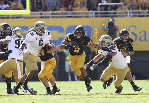 Freshman running back D.J. Foster breaks through the hole at the line of scrimmage in ASU’s 45-43 loss to UCLA on Oct. 27. (Photo by Sam Rosenbaum)