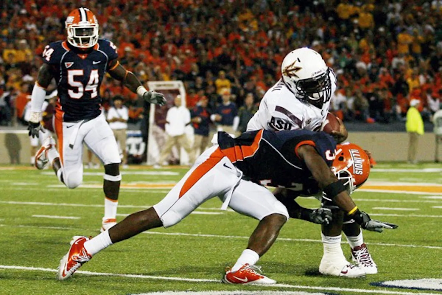 Daryl Quitalig The Daily Illini
Illinois' Tavon Wilson (3) tackles Arizona State's Cameron Marshall (6) during the game at Memorial Stadium. The Illini won 17-14.