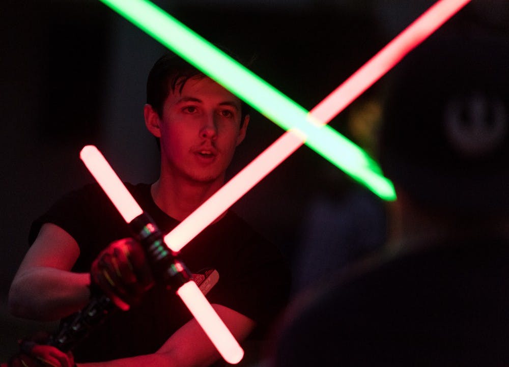 Richard Bannon, an economics major at Scottsdale Community College, gives new light saber participants tips on how to improve their fighting techniques at the ASU Light Saber club meeting held at the Secret Garden on the ASU Tempe Campus on Tuesday, Aug. 23, 2016.