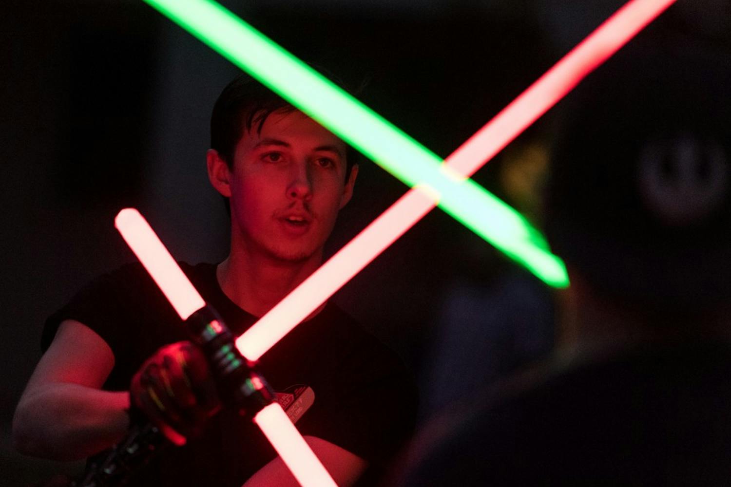 Richard Bannon, an economics major at Scottsdale Community College, gives new light saber participants tips on how to improve their fighting techniques at the ASU Light Saber club meeting held at the Secret Garden on the ASU Tempe Campus on Tuesday, Aug. 23, 2016.