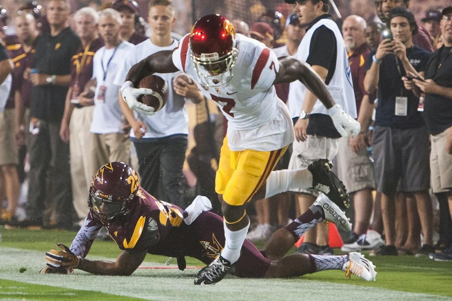 Wide receiver Stephen Mitchell Jr. (7) is forced out of bounds by defensive back Kareem Orr (25) after completing a pass from quarterback Cody Kessler for the University of Southern California first down on Saturday, Sept. 26, 2015, at Sun Devil Stadium in Tempe.