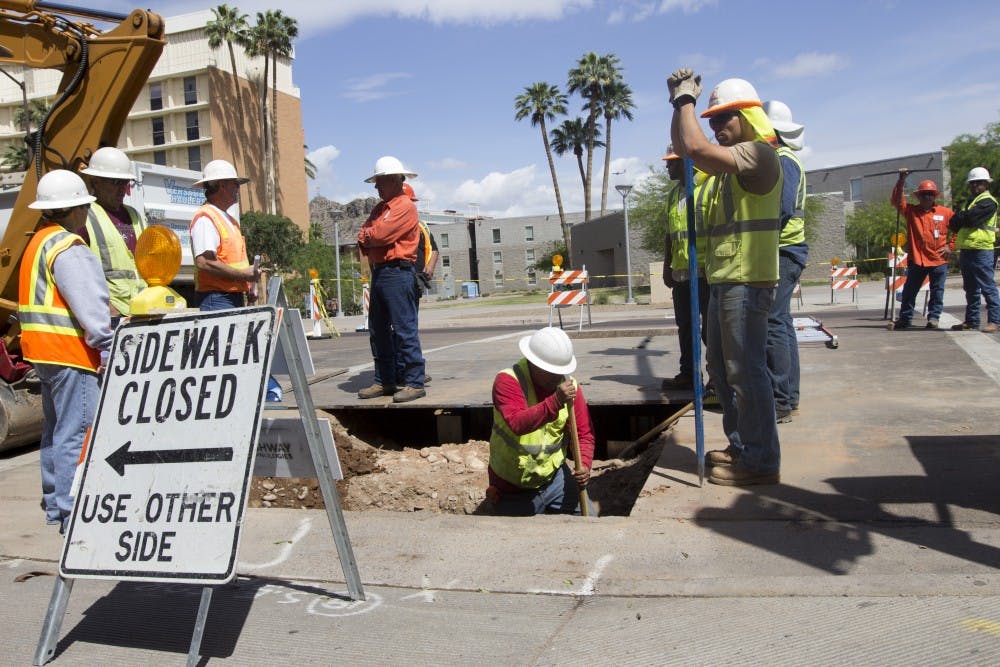 Construction workers excavate a piece of road near campus.The Tempe City Council’s decision to resurface Rural Road will
extend traffic delays in the area to early November instead of the 
end of October. (Photo by Dominic Valente) 
