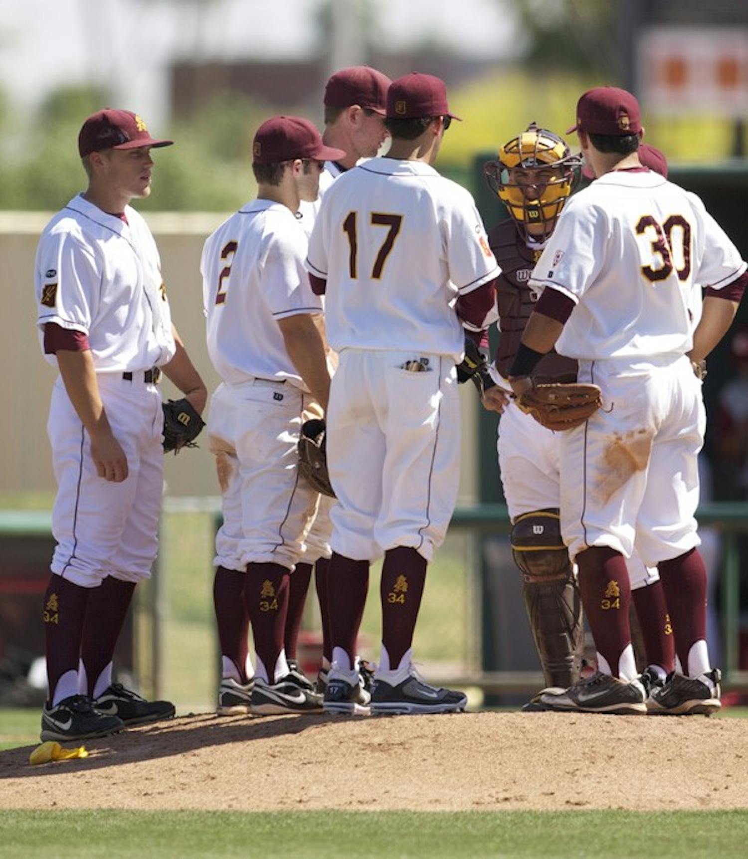 Final Meeting: ASU sophomore Deven Marrero (17), junior Riccio Torrez (30) and the rest of the infielders meet at the mound during the Sun Devils’ victory over Washington State on April 17. ASU meets UA for the fifth time this season on Tuesday. (Photo by Scott Stuk)