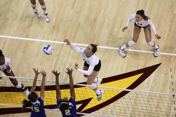 Freshman outside hitter Macey Gardner attempts to hit the ball past two UC Riverside blockers during the Sun Devils’ 3-1 win over the Highlanders on Sept. 14. (Photo by Kyle Newman)