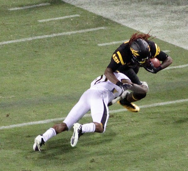 FIGHTING FORWARD: Senior wide receiver George Bell (ball) attempts to shake of a Missouri defender during the Sun Devils’ 37-30 win over the Tigers on Sept. 9. Although he’s not a starter, the Southwestern Community College transfer has become a reliable option for junior quarterback Brock Osweiler. (Photo by Beth Easterbrook)