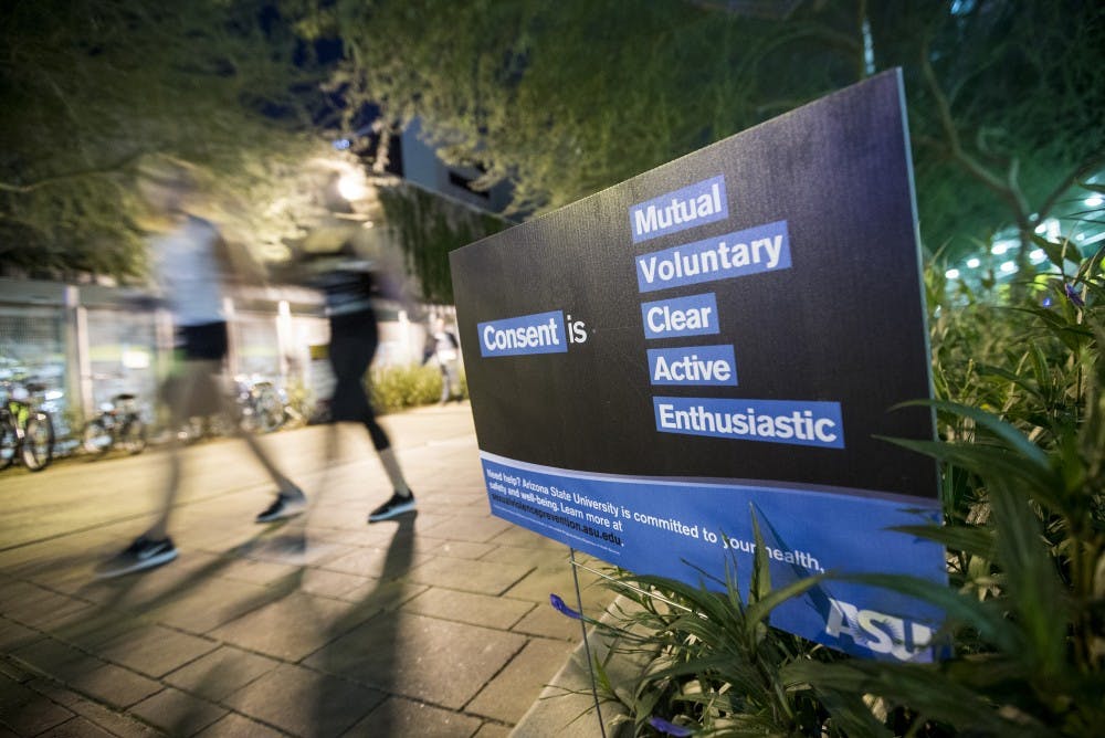 Students walk by an ASU consent sign on Taylor Mall in Downtown Phoenix on Monday, Sept. 26, 2016.