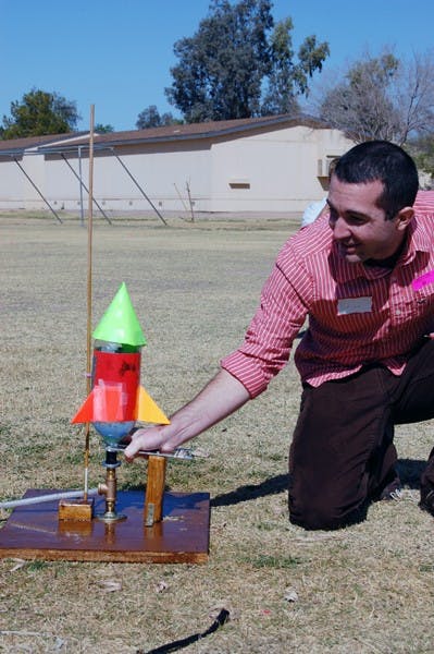 Sanborn Elementary School students cheered as Arizona Science Outreach volunteer and ASU engineering graduate Brian Proulx placed the soda bottle rocket on the launch pad in hopes their rocket would win first place. (Photo by Thania A. Betancourt)