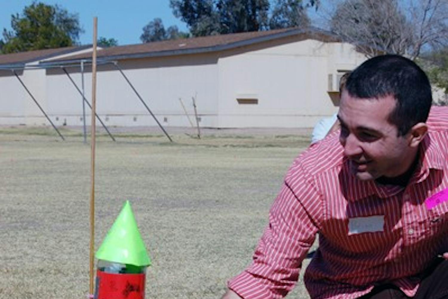 Sanborn Elementary School students cheered as Arizona Science Outreach volunteer and ASU engineering graduate Brian Proulx placed the soda bottle rocket on the launch pad in hopes their rocket would win first place. (Photo by Thania A. Betancourt)