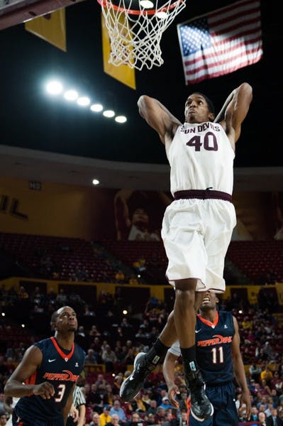 Senior forward Shaquille McKissic dunks the ball in a game against Pepperdine, Saturday, Dec. 13, 2014 at Wells Fargo Arena in Tempe. After trailing the entire first half, the Sun Devils came from behind and defeated the Waves 81-74. (Photo by Ben Moffat)