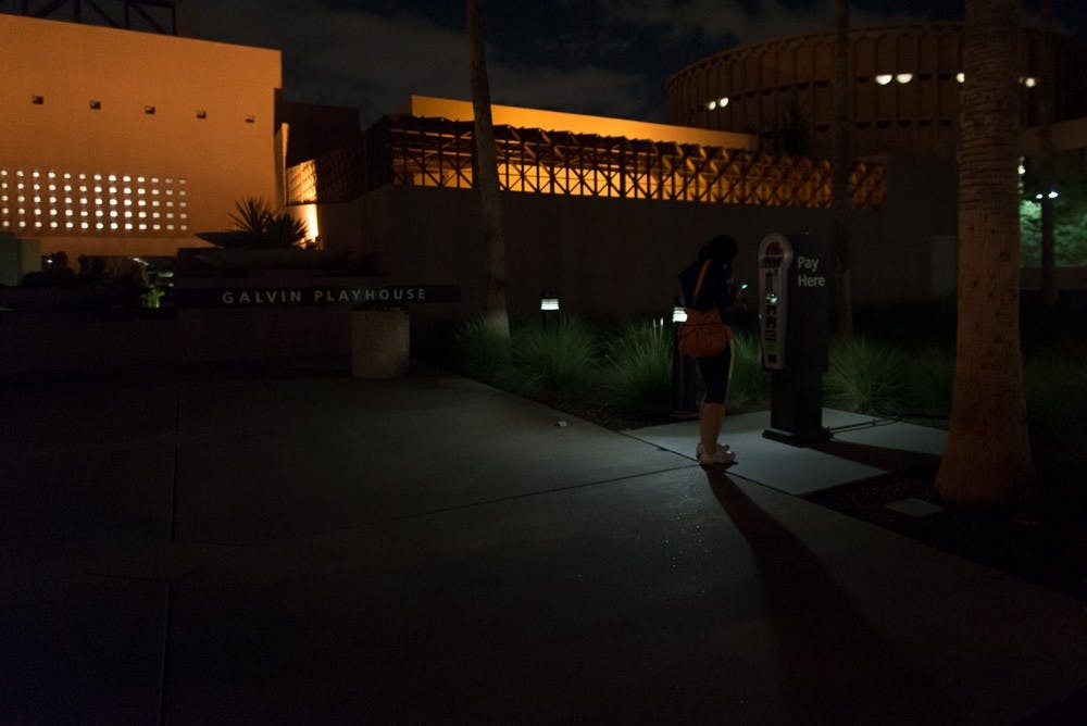 A woman pays for parking in a dimly lit area outside the Galvin Playhouse on Monday, Oct. 5, 2015, on the Tempe campus.