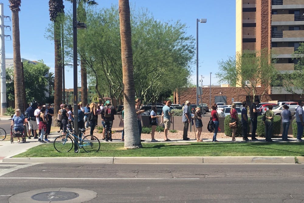 Voters line up outside the Salvation Army Citadel on Third Avenue and Fillmore Street on Tuesday, March 23, 2016, in Phoenix.