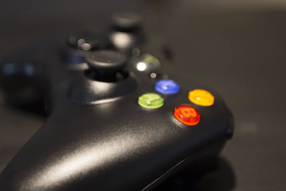 An Xbox 360 controller sits on display 