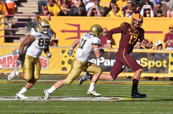 LAST LEGS: Sophomore quarterback Brock Osweiler scrambles from UCLA defenders during last week’s 55-34 ASU win. This week, Osweiler is tasked with picking apart a UA defense that has faltered recently. The Sun Devils need a win to preserve their chance to receive an NCAA waiver for a bowl game. (Photo by Aaron Lavinsky)