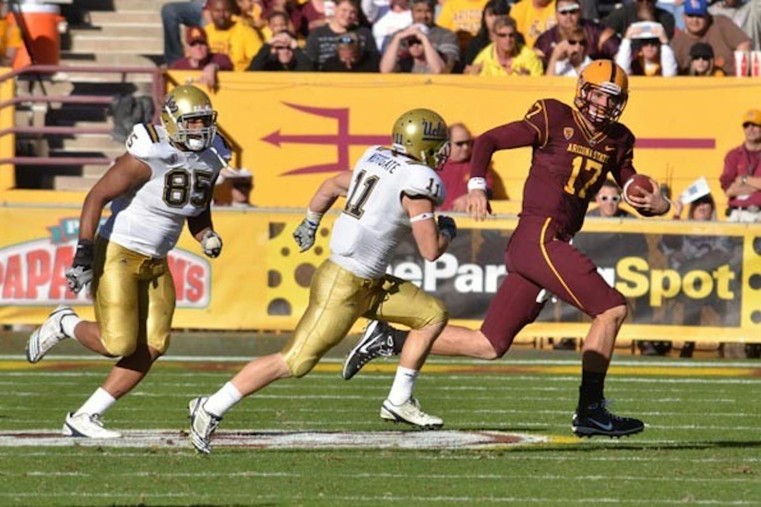 LAST LEGS: Sophomore quarterback Brock Osweiler scrambles from UCLA defenders during last week’s 55-34 ASU win. This week, Osweiler is tasked with picking apart a UA defense that has faltered recently. The Sun Devils need a win to preserve their chance to receive an NCAA waiver for a bowl game. (Photo by Aaron Lavinsky)