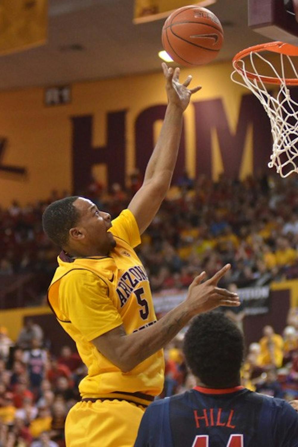 Tip drill: ASU freshman forward Kyle Cain goes up for a layup against UA on Feb. 13 in Tempe. After stopping a nine-game losing streak last Saturday against Washington State, the Sun Devils have had more energy in recent practices. (Photo by Aaron Lavinsky)