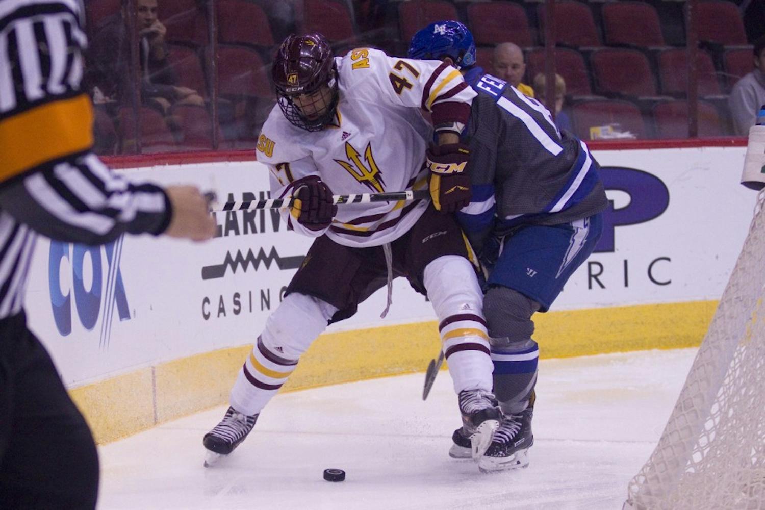 ASU sophomore right defender Nicholas Gushue (47) holds off an Air Force defenseman in a 5-2 victory against Air Force in Gila River Arena in Glendale, Arizona, on Sunday, Oct. 16, 2016.