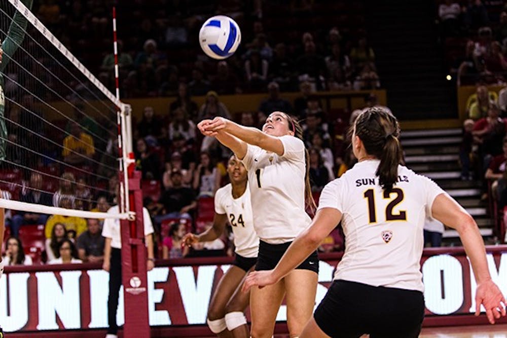 Junior setter Bianca Arellano sets the ball for junior outside hitter Macey Gardner at the beginning of the third set of the ASU vs Oregon volleyball game at the Wells Fargo Arena on November 11th, 2014. The Sun Devils would drop a close third set 26-24 to the Ducks and would be defeated in five sets 3-2. (Photo by Daniel Kwon)