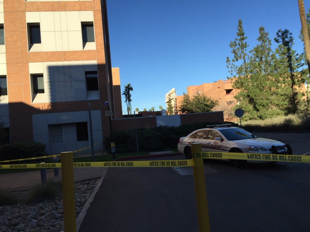 ASU Police cars are seen outside the Goldwater Building Friday, Feb. 13, 2015. Early Friday morning, a body was found near the building.