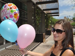 HAPPY BIRTHDAY: Emily Parks, a sophomore in social work shows off balloons for her roommate's birthday outside of Taylor Place on the downtown campus. (Photo by Christopher Leone)