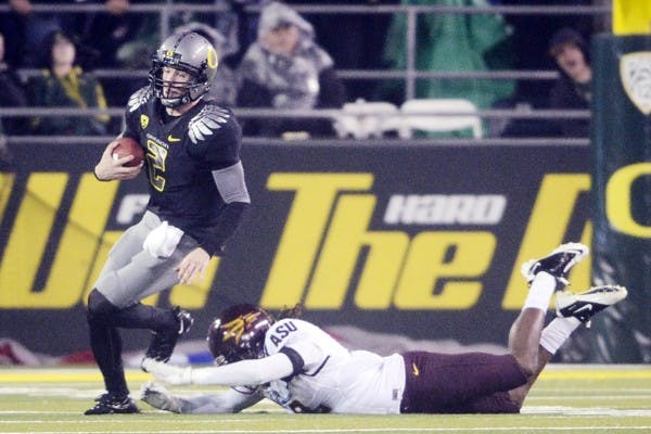 BACKUP SPARK: Oregon redshirt freshman quarterback Bryan Bennett runs sprints past a tackle during the Ducks’ win on Saturday. Bennett came on when junior quarterback Darron Thomas went down in the third quarter due to a knee injury. (Photo courtesy of Aaron Marineau | Oregon Daily Emerald)