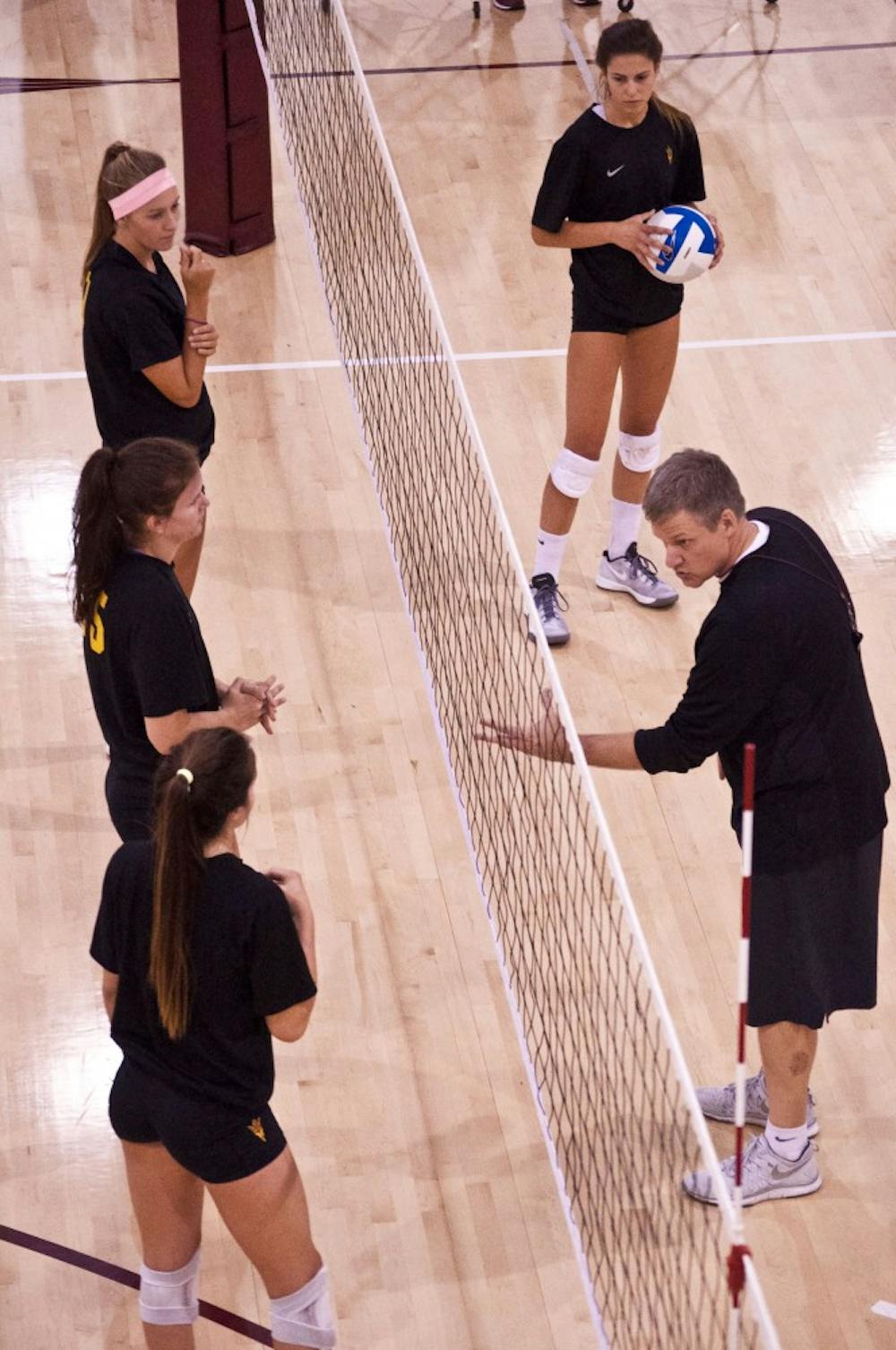 Jason Watson, the head coach of the ASU women’s volley ball team, gives his athletes blocking advice during a practice. The girls constantly rotate players on and off the court so they all go through the same practice drills. (Photo by Katie Dunphy)