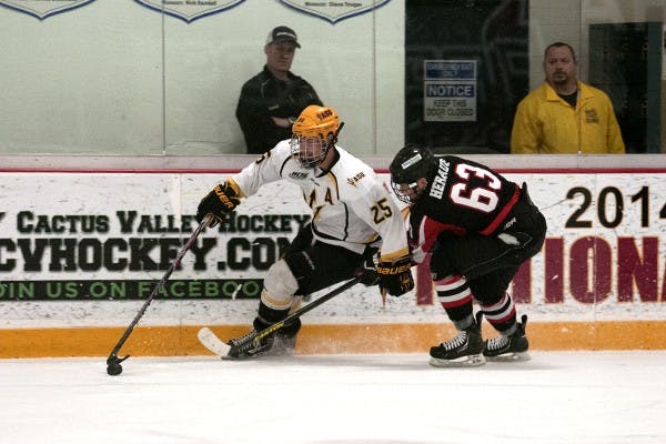 Forward Liam Norris fights Minot State defender for possession. ASU defeated Minot State 5-3 on Nov. 13, 2014 at Oceanside Arena. (Photo by Mario Mendez)