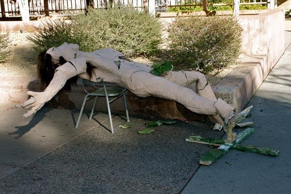 WHERE'S EVE?: A paper mache man, that looks like Adam, lays outside infront of the Memorial Union on Monday. (Photo by Rosie Gochnour)