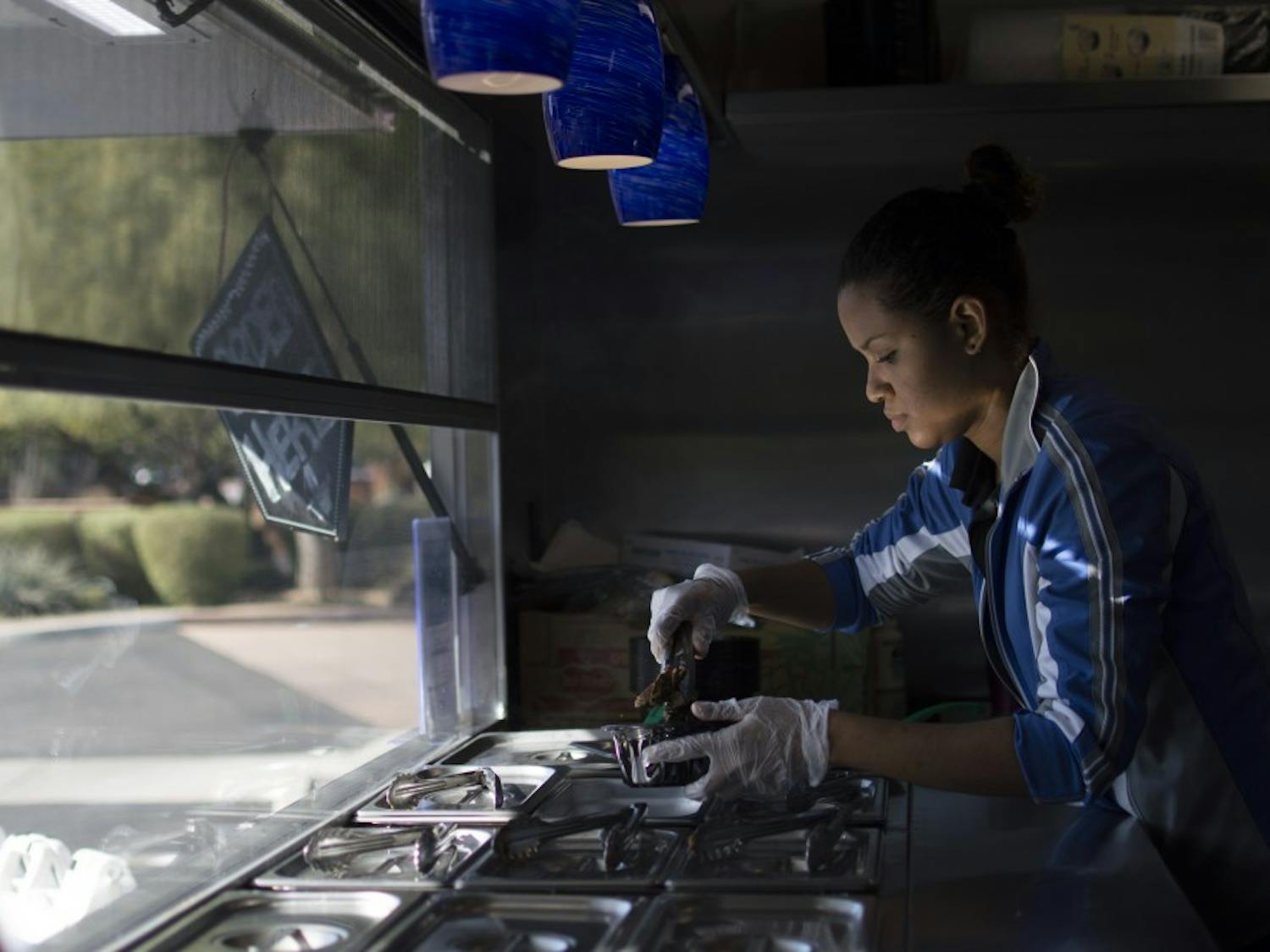 Sous Chef Myra Segura prepares a Carne Asade bowl in the Wandering Donkey's Food Truck on Thursday, Jan. 21, 2016 in Scottsdale.&nbsp;