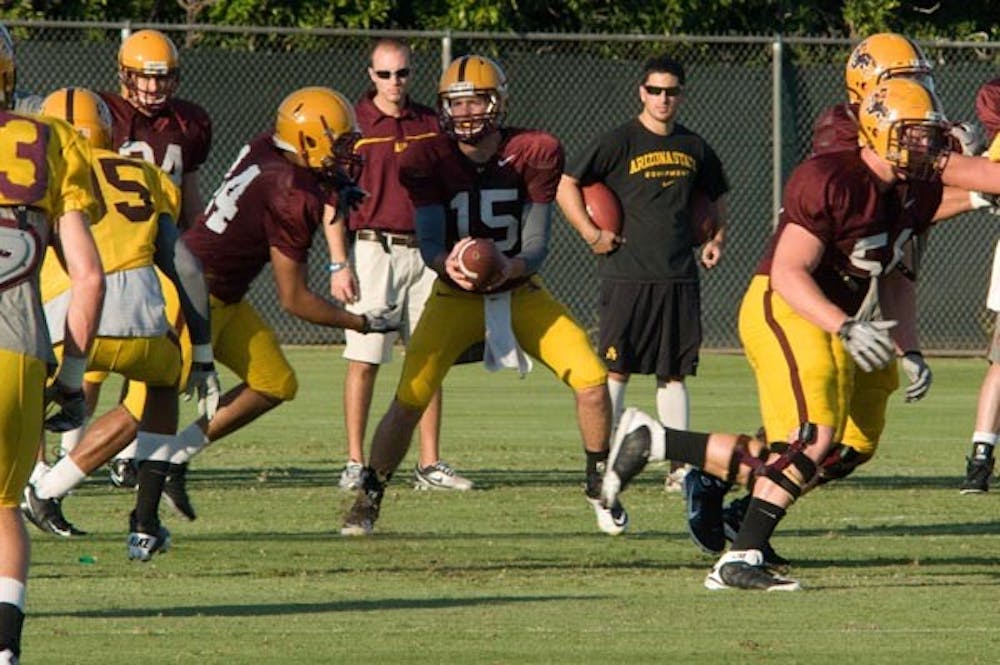 SCOUTING REPORT: Freshman quarterback Taylor Kelly leads the offense during a scout team scrimmage at football practice Thursday. Kelly was 7-of-10 passing with a touchdown in the midseason scrimmage. (Photo by Aaron Lavinksy)